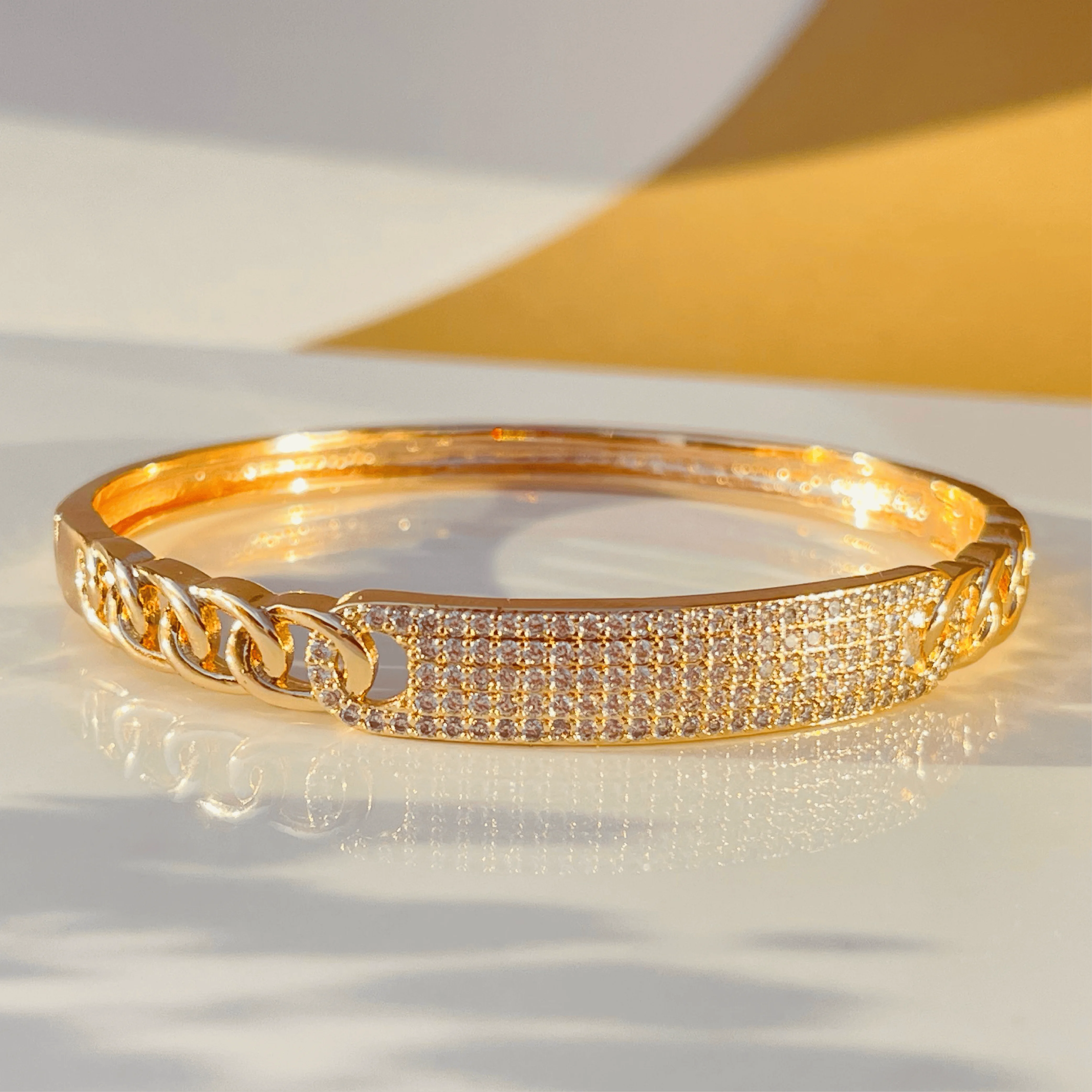 Radiant Link Gold Bangle with White Stone Center