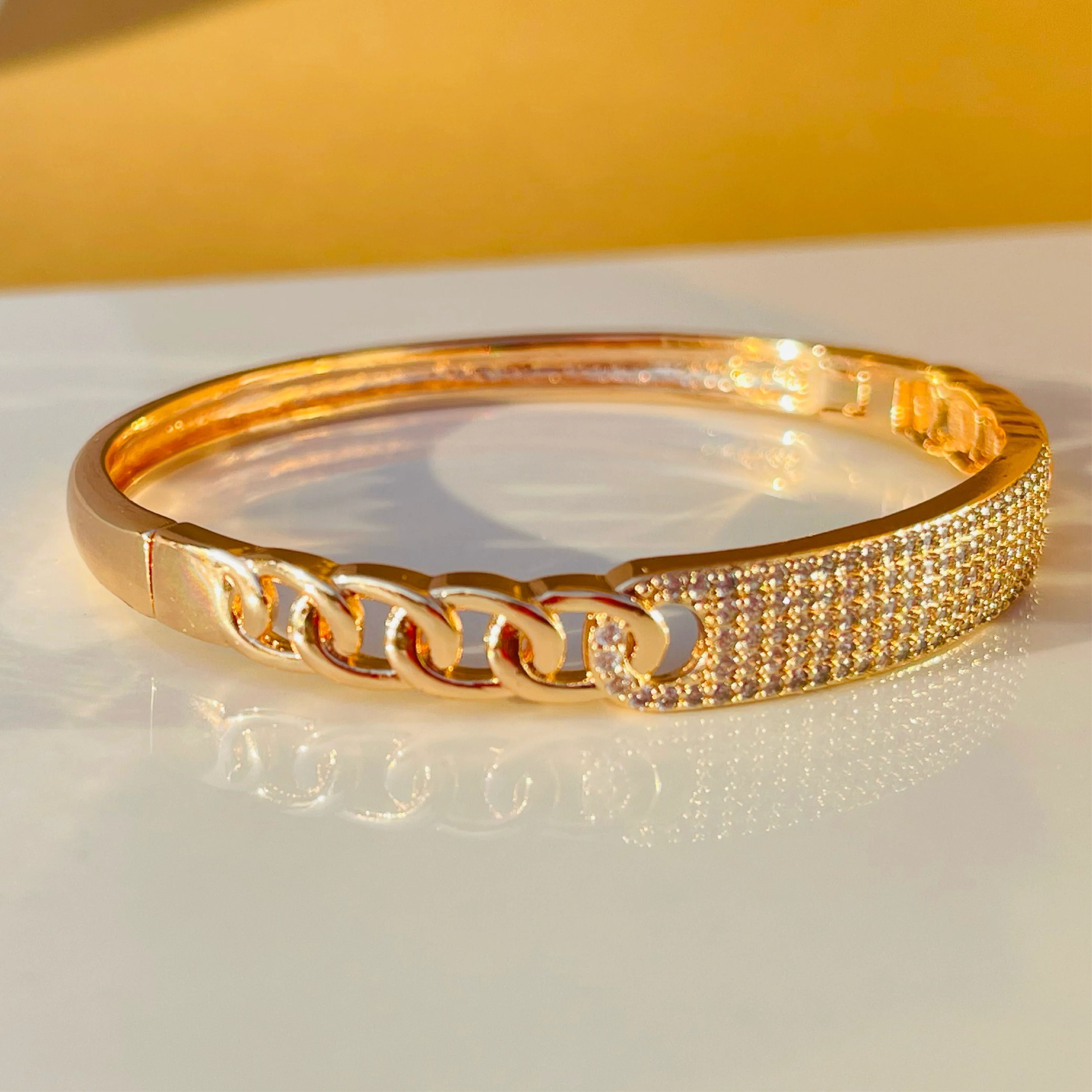Radiant Link Gold Bangle with White Stone Center
