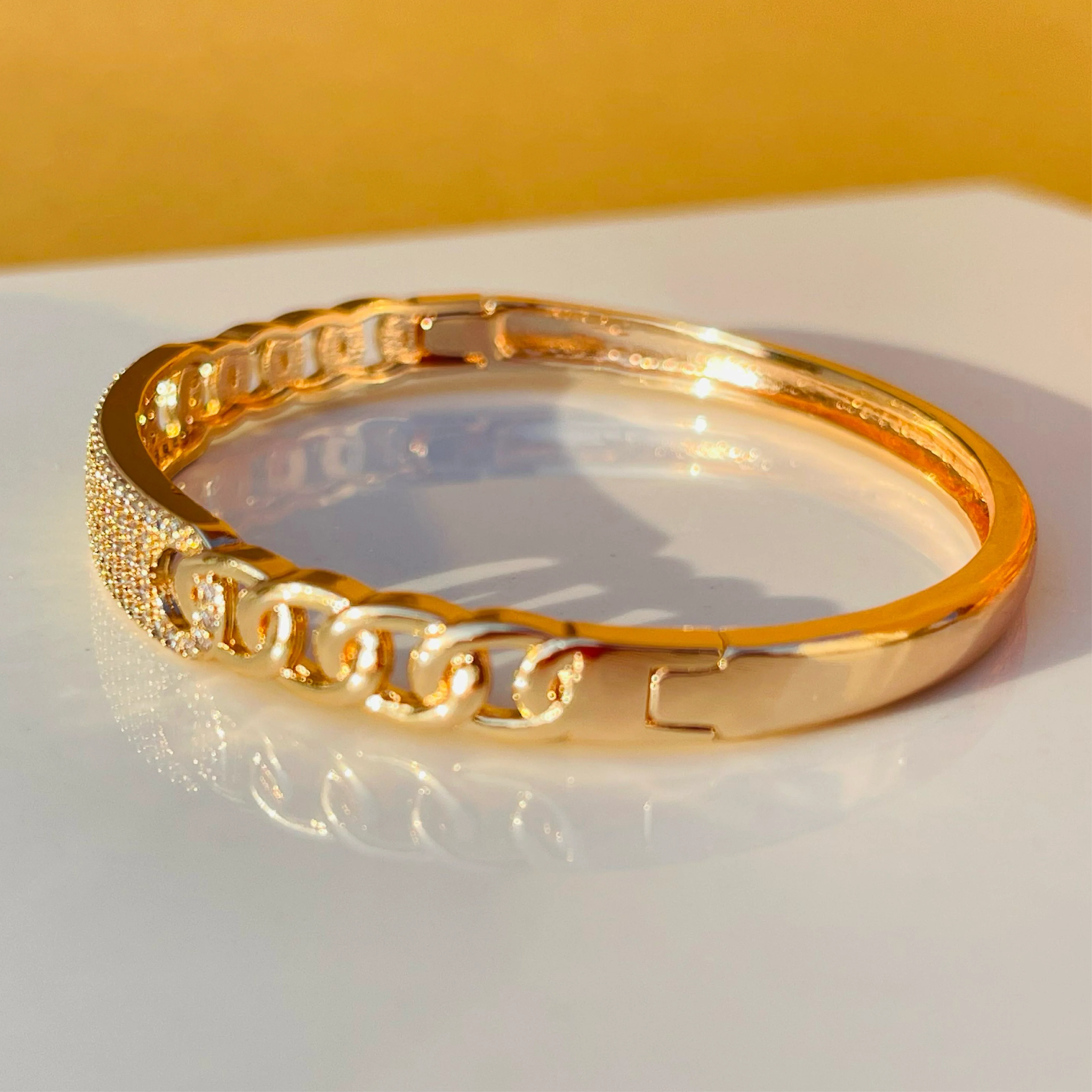 Radiant Link Gold Bangle with White Stone Center